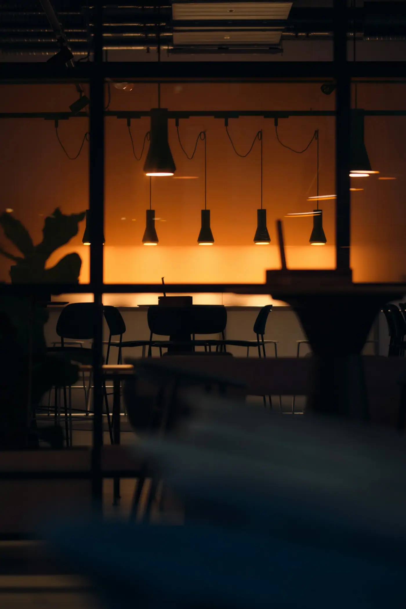 Pendant lights glowing over a modern dining area